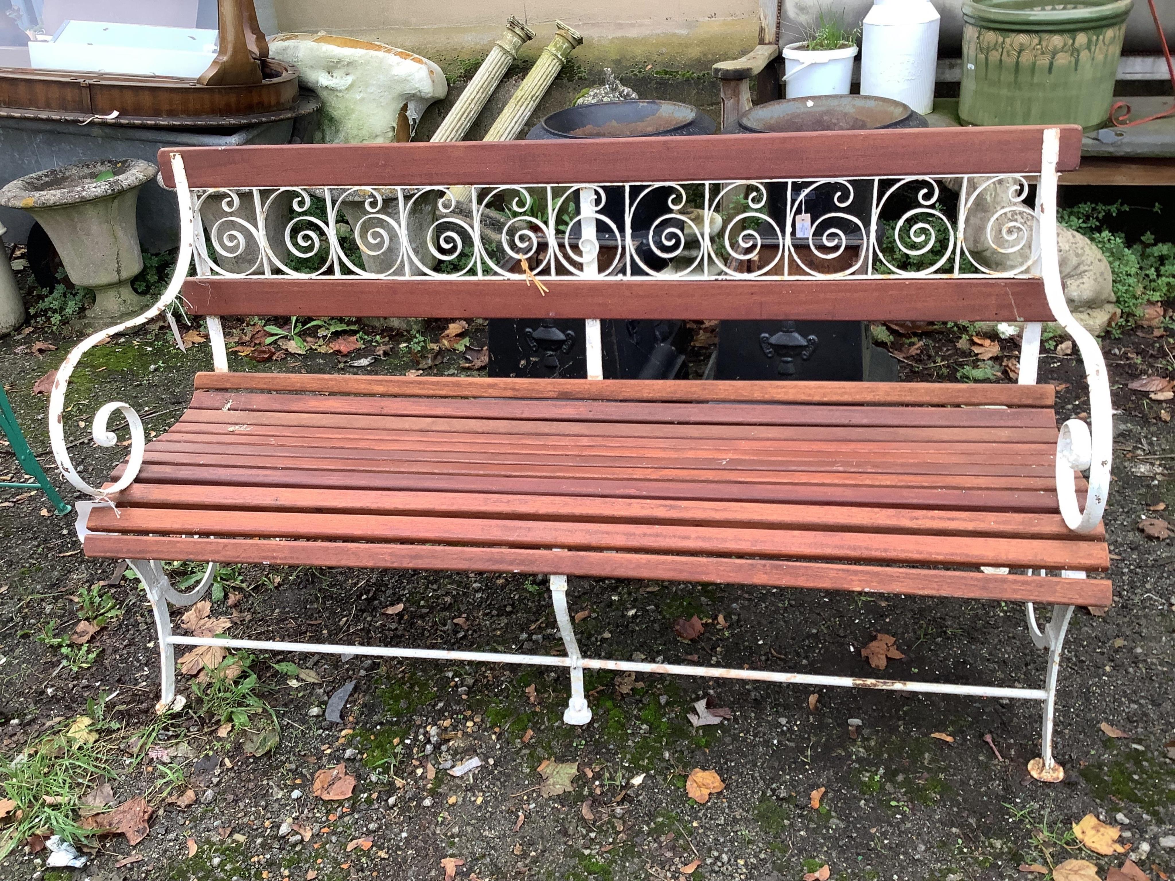 A slatted teak wrought iron garden bench, width 155cm and a pair of similar painted chairs. Condition - some paint loss, otherwise fair